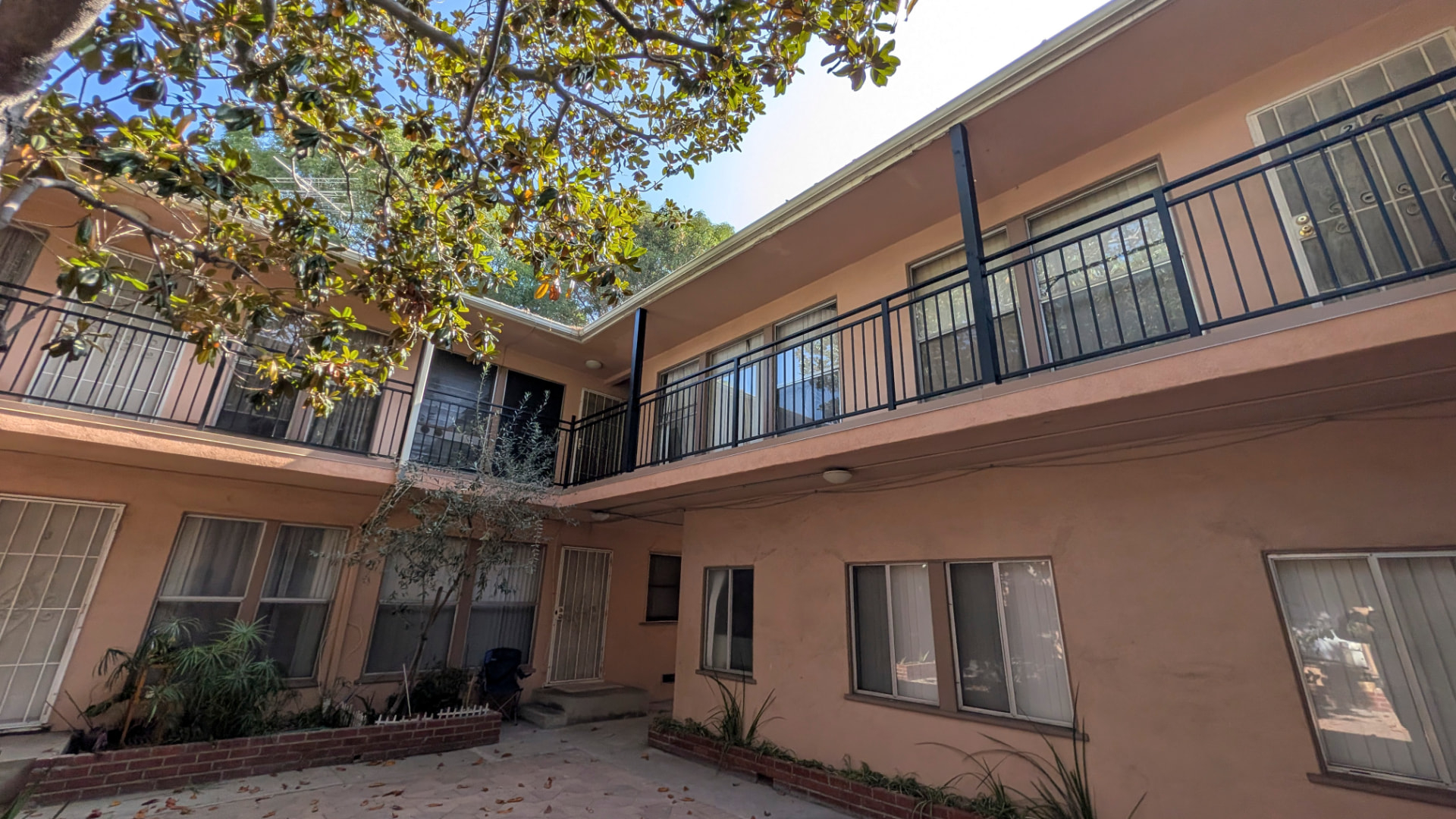 Hollywood, CA apartment building with new powder-coated metal guardrails on its upper-floor walkways after RetroCal structural repair and waterproofing.