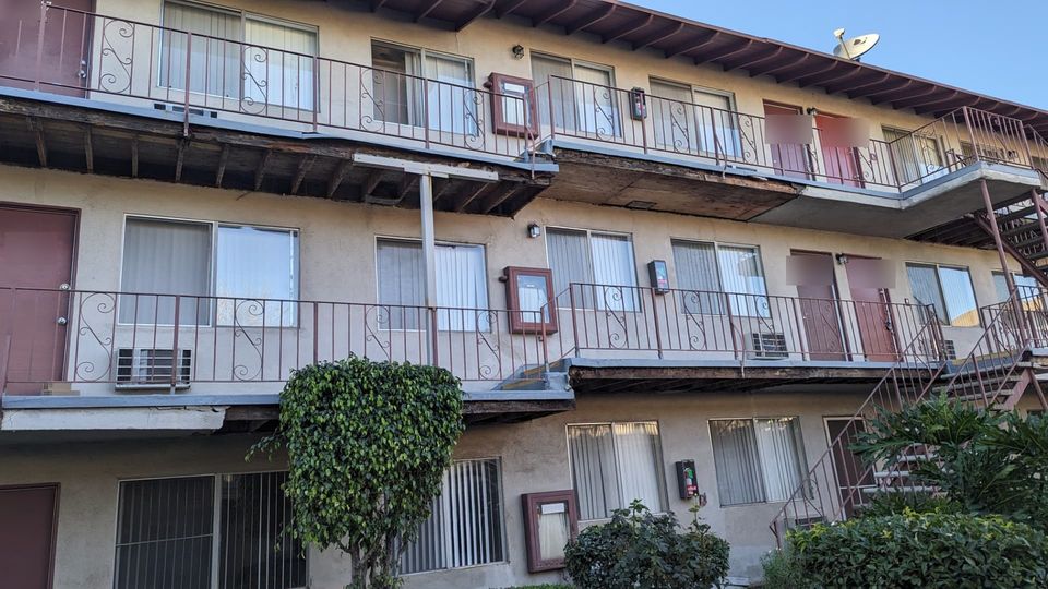 Arcadia apartment courtyard before repair with multiple open and deteriorated walkway areas.