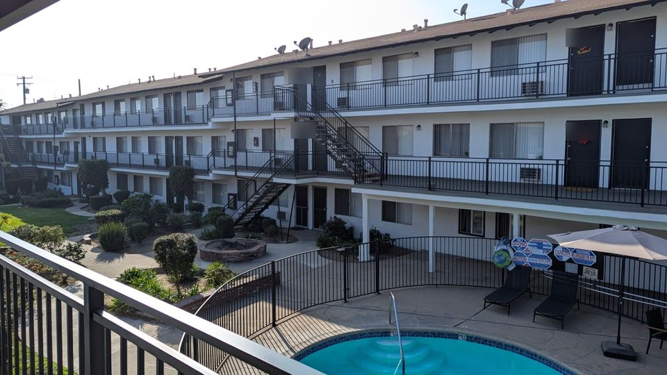 Completed Arcadia apartment courtyard with restored multi-level walkways around the pool area.